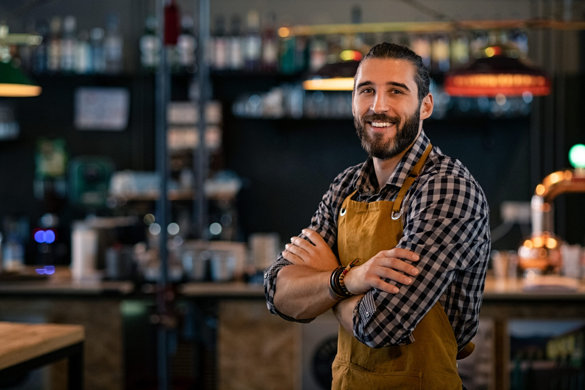 Bartender standing in front of the room with his arms crossed.